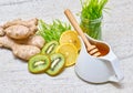 Honey in a pot, Green wheat, lemon and ginger, kiwi for a fresh juice or detox smoothie Royalty Free Stock Photo