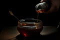 Honey is poured from jar into cup of tea. Generative AI