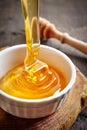 Honey pouring into bowl