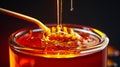 Honey pouring into a glass with a wooden spoon Royalty Free Stock Photo