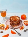 Honey pouring over a stack of mini pancakes. The concept of a delicious breakfast