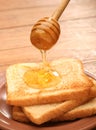 Honey pouring over toast bread