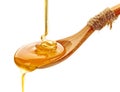Honey pouring into wooden spoon Royalty Free Stock Photo