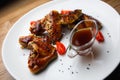 Honey sause glazed chicken wings with sesame seeds in white plate