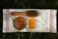 Honey soap lies on a light cotton towel. Nearby lies a body brush and natural honey. Set of accessories for sauna and steam room.