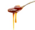 Honey in Spoon dripping isolated on black background Royalty Free Stock Photo