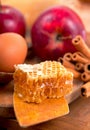 honey spoon, jar of honey, apples and cinnamon on a wooden background in a rustic style Royalty Free Stock Photo