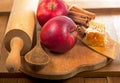 honey spoon, jar of honey, apples and cinnamon on a wooden background in a rustic style Royalty Free Stock Photo