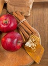 honey spoon, jar of honey, apples and cinnamon on a wooden background in a rustic style Royalty Free Stock Photo