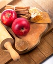 honey spoon, jar of honey, apples and cinnamon on a wooden background in a rustic style Royalty Free Stock Photo