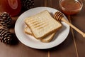 Honey with stick pouring over bread Royalty Free Stock Photo