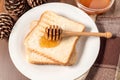 Honey with stick pouring over toast Royalty Free Stock Photo