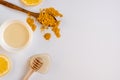 Honey stick, spoon with turmeric and lemon slices top view, copy