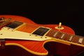 Honey sunburst vintage electric jazz guitar closeup on black background. Shallow depth of field. Royalty Free Stock Photo