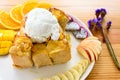 Honey toast with coconut ice cream and fruits on a wooden table. Royalty Free Stock Photo