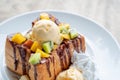 Honey toast ice cream vanilla with sliced fruits and chocolate s Royalty Free Stock Photo