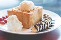 Honey toast with vanilla ice cream, whipped cream and chocolate syrup Royalty Free Stock Photo