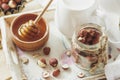 Honey in the wooden bowl, hazelnuts and jar with milk on the wooden tray Royalty Free Stock Photo