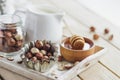 Honey in the wooden bowl, hazelnuts and jar with milk on the wooden tray Royalty Free Stock Photo