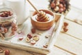 Honey in the wooden bowl, hazelnuts and jar with milk on the wooden tray Royalty Free Stock Photo