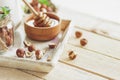 Honey in the wooden bowl, hazelnuts and jar with milk on the wooden tray Royalty Free Stock Photo