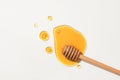 Honey and a wooden honey drizzle displayed on a white background. Vitamin C and antioxidants in honey help protect the skin from Royalty Free Stock Photo