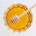 Honey with wooden honey dipper in the glass jar top view Royalty Free Stock Photo