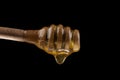 Honey wooden spoon isolated on a black Royalty Free Stock Photo