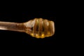 Honey wooden spoon isolated on a black Royalty Free Stock Photo