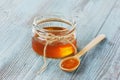 Honey in a wooden spoon and jar Royalty Free Stock Photo