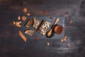 Honeycomb, bee pollen granules, honey jar with wooden dipper, almond nuts on black slate tray over dark background. Copy space. Royalty Free Stock Photo