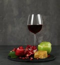 Honeycomb, fruits and wine on grey table, space for text. Rosh Hashanah holiday