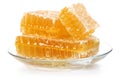 Honeycomb in glass dish on white background