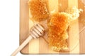 Honeycomb honey with diper on a wooden cutting board Royalty Free Stock Photo
