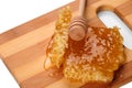 Honeycomb honey with diper on a wooden cutting board Royalty Free Stock Photo