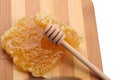 Honeycomb honey with diper on a wooden cutting board Royalty Free Stock Photo