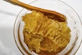 Honeycomb honey in glass bowl with wooden spoon Royalty Free Stock Photo