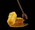 Honeycomb with honey spoon isolated on black background, bee   natural ingredients concept Royalty Free Stock Photo