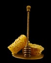 Honeycomb with honey spoon isolated on black background, bee natural ingredients concept Royalty Free Stock Photo