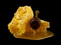 Honeycomb with honey spoon isolated on black background, bee natural ingredients concept Royalty Free Stock Photo