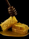 Honeycomb with honey spoon isolated on black background, bee natural ingredients concept Royalty Free Stock Photo