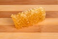 Honeycomb with honey on a wooden cutting board