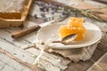 Honeycomb and wooden honey dipper. Raw honey. Natural honey, closeup view Royalty Free Stock Photo