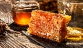 Honeycombs in closeup. Golden honeycomb on a wooden background. Sweet honey, pieces of combs and honey dipper