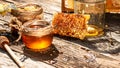 Honeycombs in closeup. Golden honeycomb on a wooden background. Sweet honey, pieces of combs and honey dipper