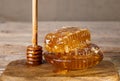 Honeycombs and honey spoon on a wooden board and table