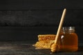 Honeycombs, jar with honey and dipper on background Royalty Free Stock Photo