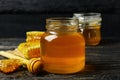 Honeycombs, jar honey and dipper on wooden background Royalty Free Stock Photo