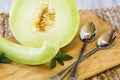 Honeydew Melon On Cutting Board With Spoons Royalty Free Stock Photo