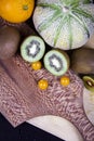 A honeydew melon, some green kiwifruits, an orange and some Chinese lanterns. Royalty Free Stock Photo